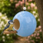 Ceramic bird feeder with bird